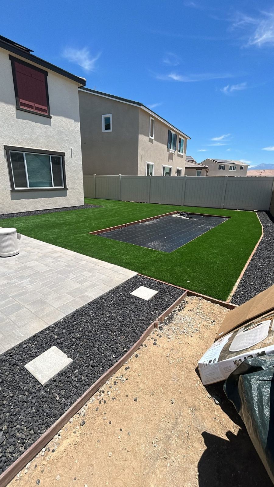 Backyard with paver patio, turf and lava rock