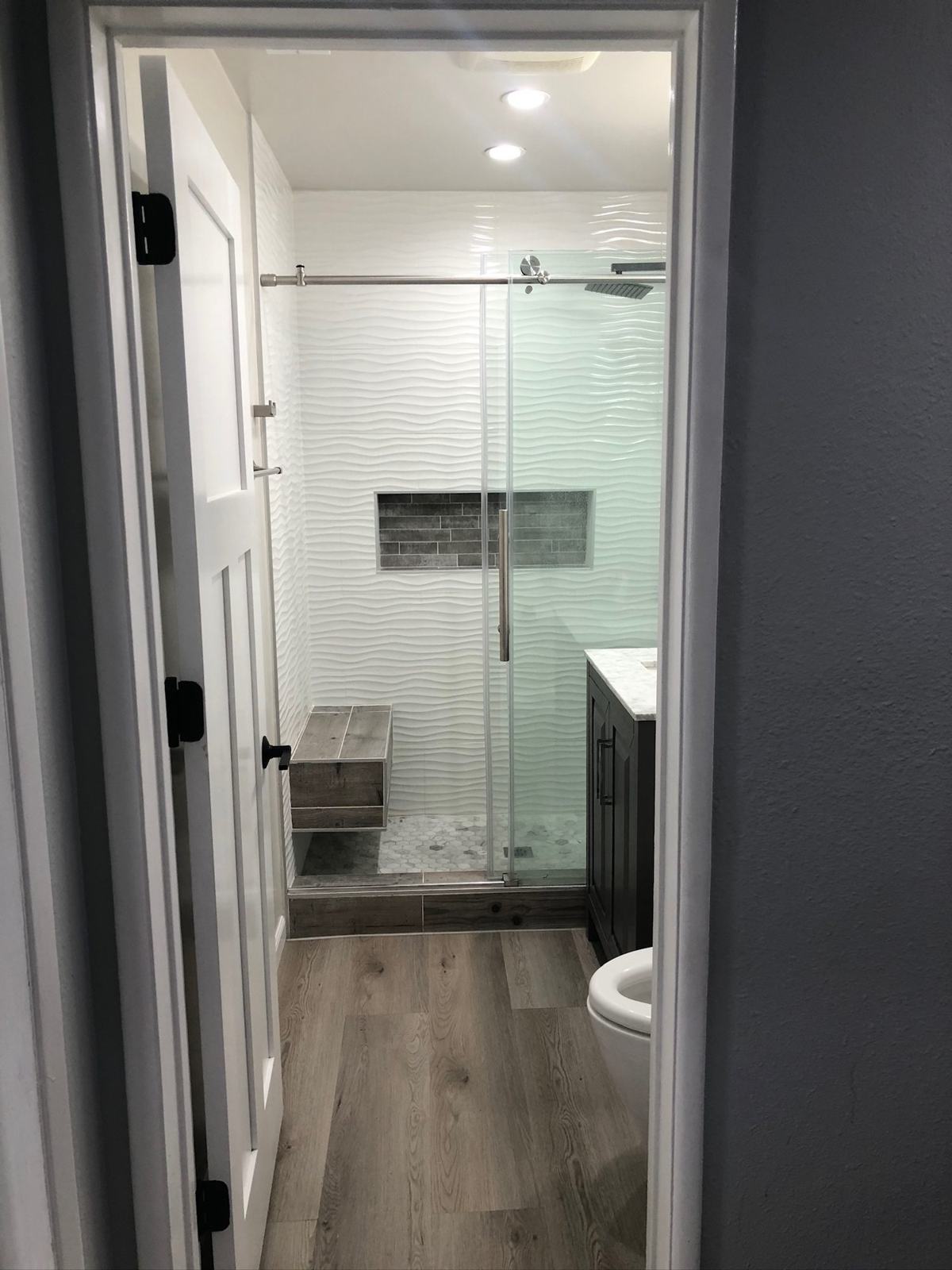 Freshly finished bathroom and hallway with new paint and flooring