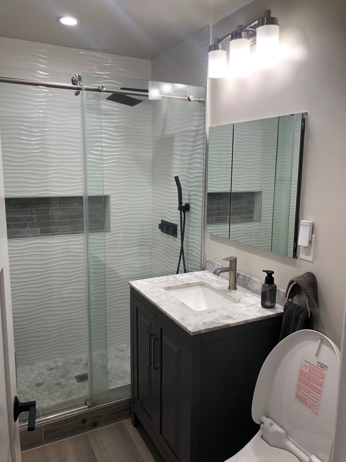 Wave tile shower with marble vanity