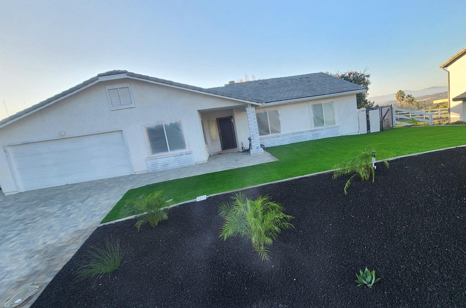Front yard with turf, pavers and rock planters