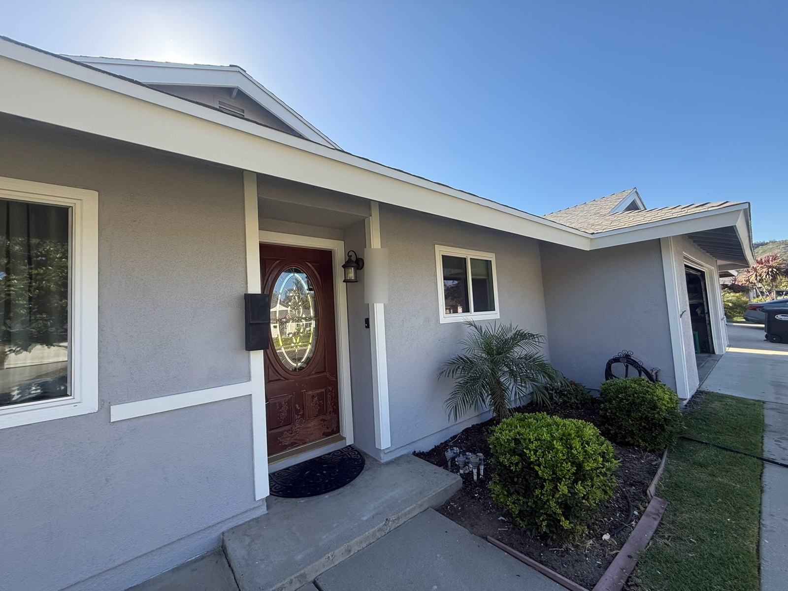 Repainted stucco home with white trim